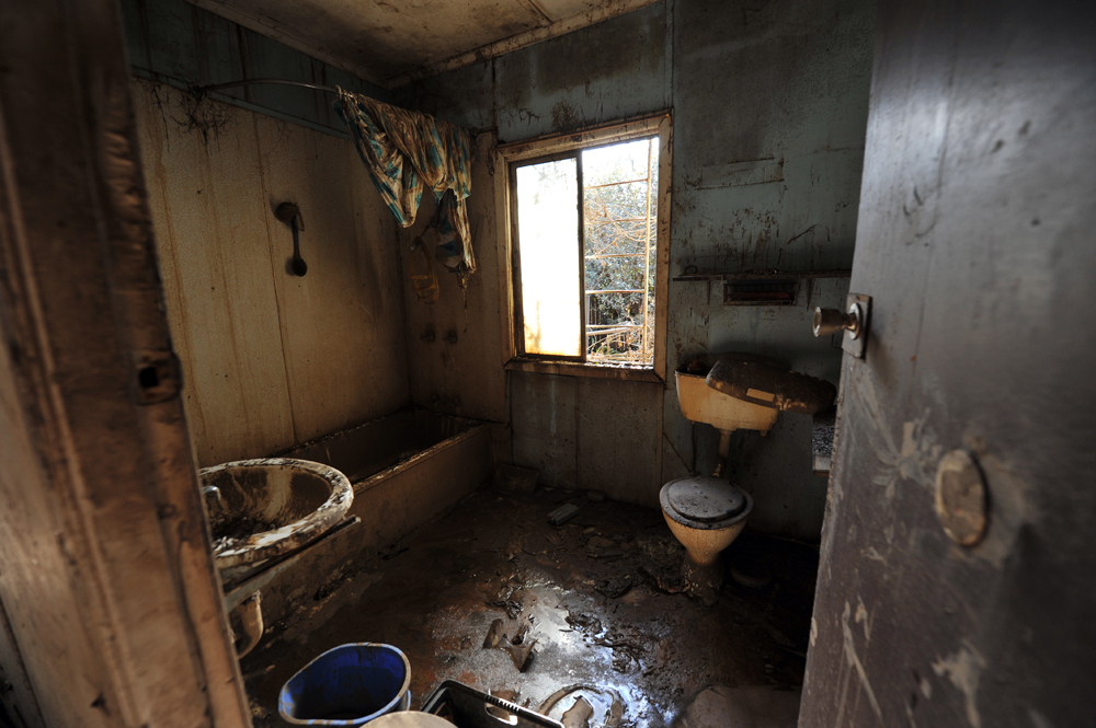Faeces and mud cover a bathroom from floor to ceiling in Goodna, Queensland.